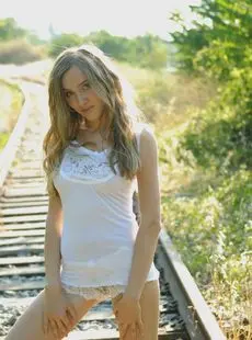 Barefoot Girl With Wavy Blonde Hair Crawls Naked While Posing On Rail Tracks