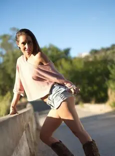 Solo Model Jess West Walks Along A Road In Nothing More Than Her Cowgirl Boots